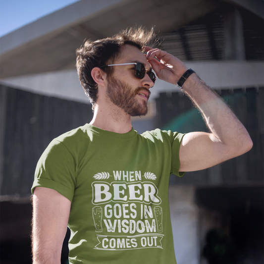 Man wearing a green t-shirt with a humorous print, standing outdoors.