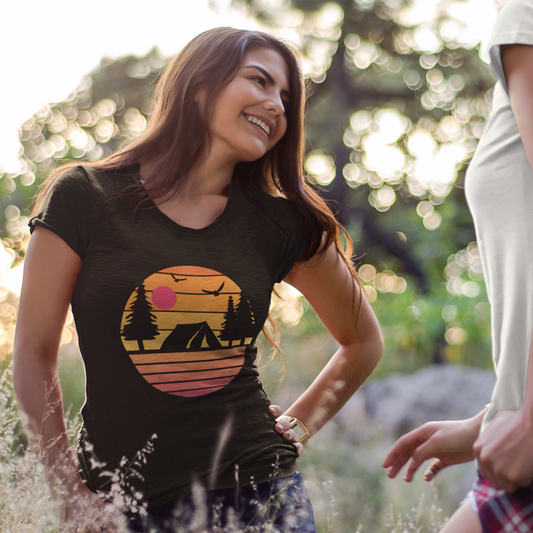 Woman wearing a black t-shirt with a nature graphic in a park setting