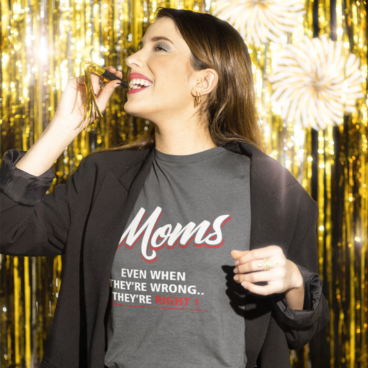 Woman wearing a shirt with text in front of a gold curtain