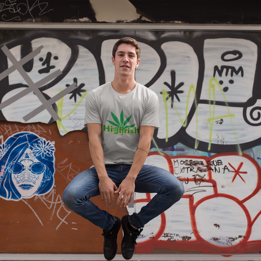 Person sitting on a bench in front of a graffiti-covered wall.