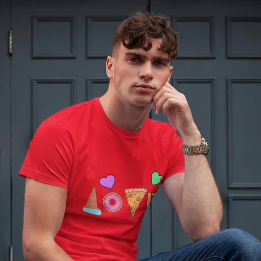 Man wearing a red t-shirt with colorful graphics sitting against a gray door.