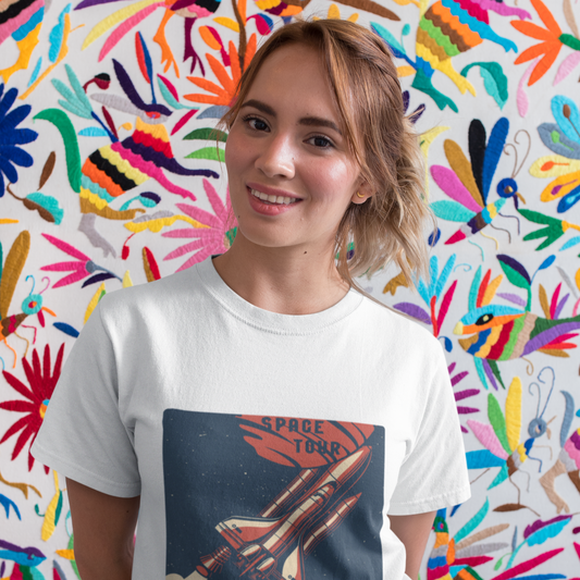 Person wearing a white t-shirt with a space-themed design against a colorful abstract wall.