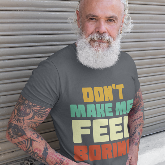 Man wearing a t-shirt with colorful text in front of a metallic shutter.