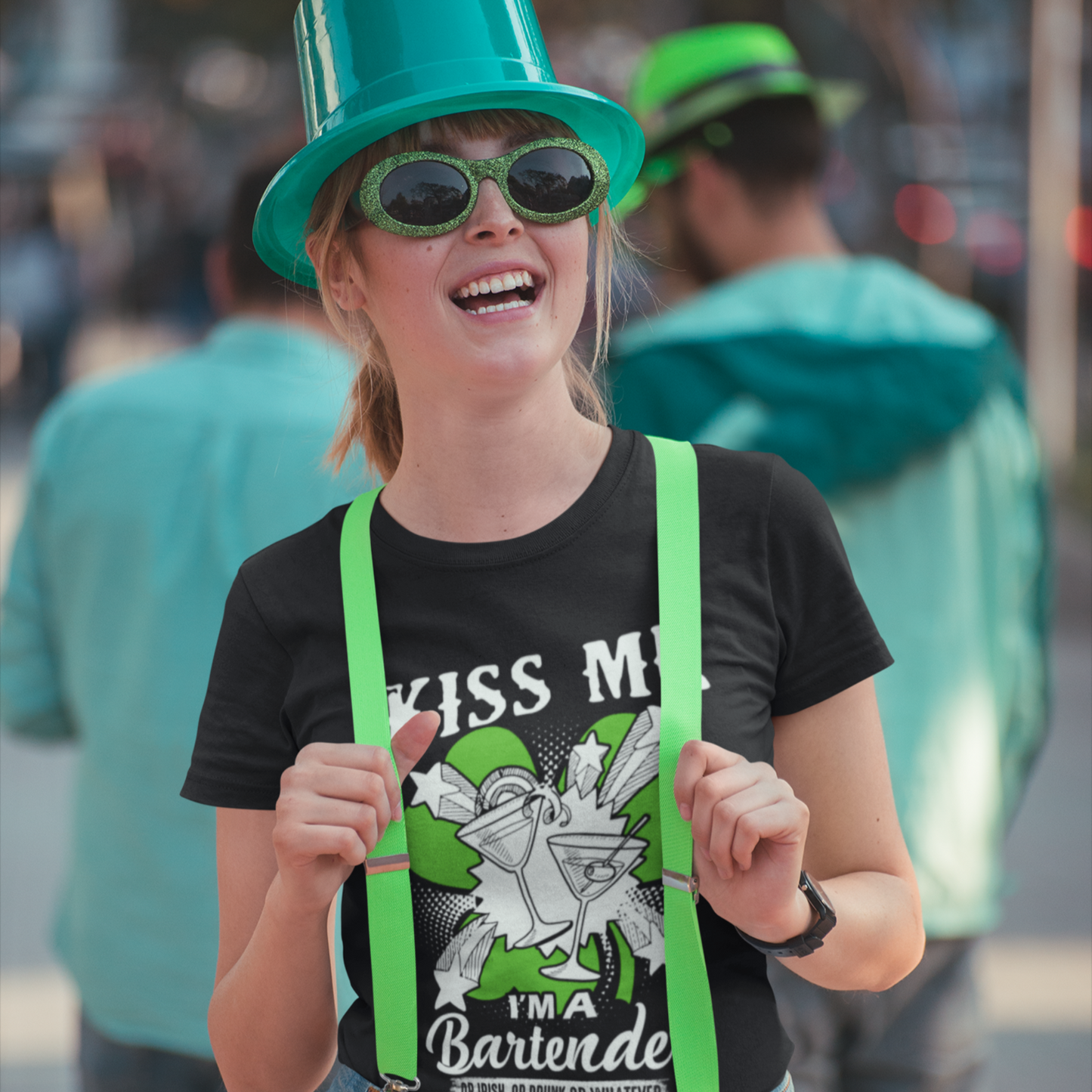 Person wearing a green top hat, sunglasses, and green suspenders with a black t-shirt.
