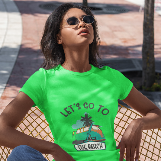 Woman wearing a bright green t-shirt with a beach graphic and text, sitting outdoors.