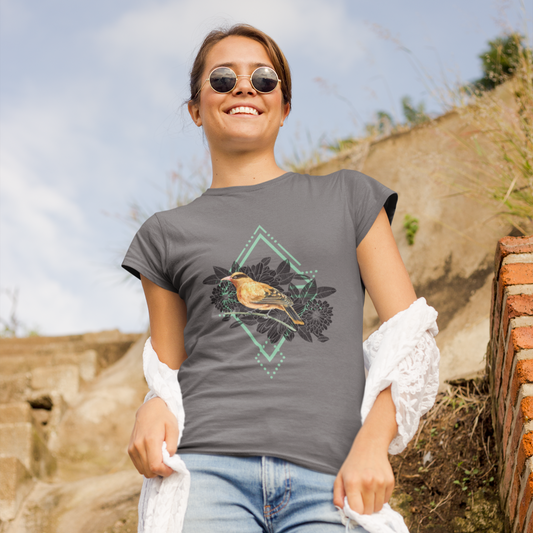Woman wearing a gray t-shirt with a bird design outdoors