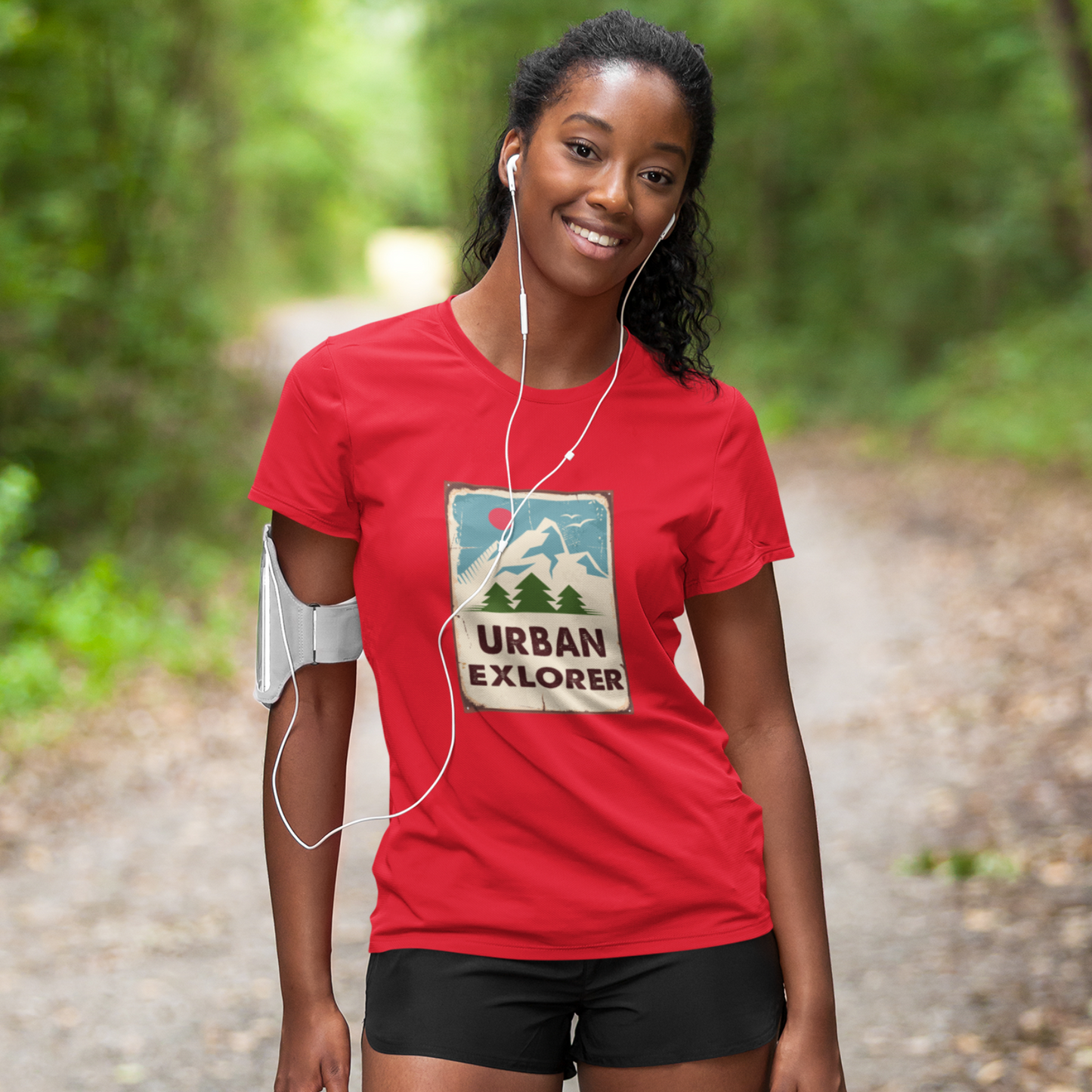 Woman wearing a red 'Urban Explorer' t-shirt on a nature trail