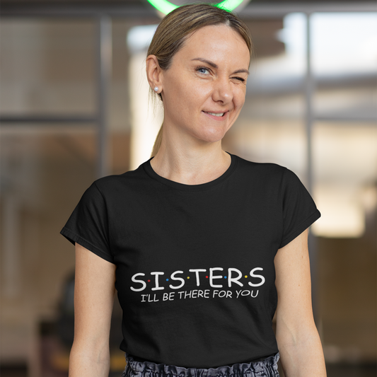 Woman wearing a black t-shirt with 'SISTERS I'll be there for you' text in an indoor setting.