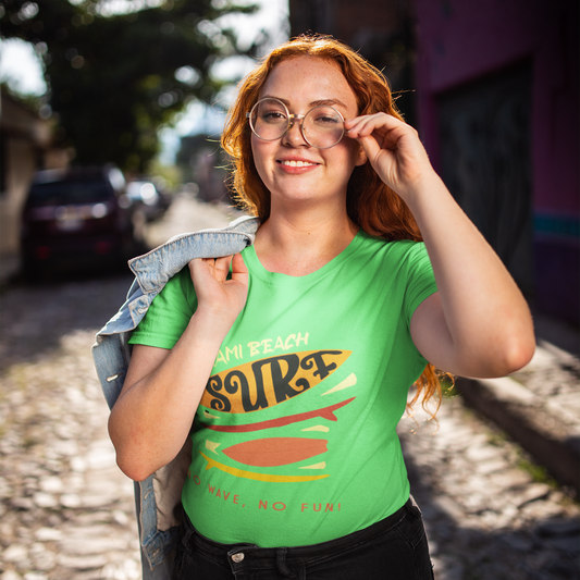 Woman wearing a green t-shirt with text and graphics, standing on a street.