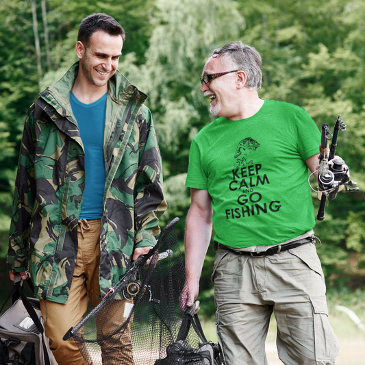 Two men walking outdoors with fishing gear, one wearing a green 'Keep Calm and Go Fishing' shirt.