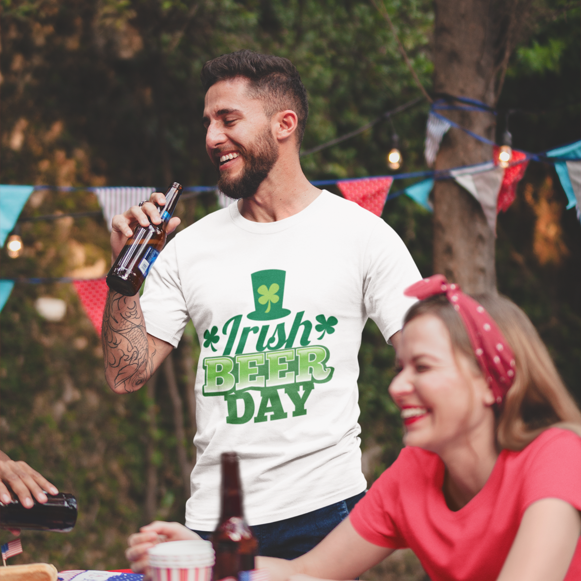 Man wearing a 'Irish Beer Day' t-shirt at a outdoor gathering with a woman.