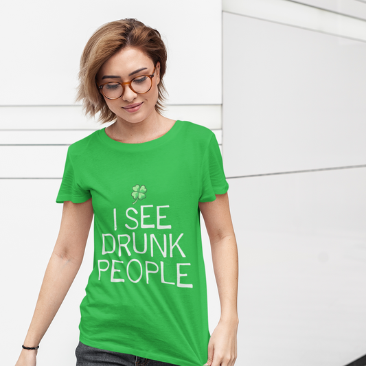 Person wearing a green t-shirt with 'I See Drunk People' text against a white wall.
