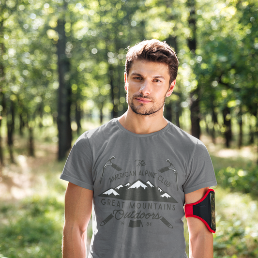 Man wearing a gray t-shirt with mountain design in a forest