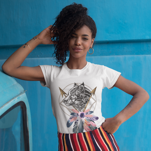 Woman wearing a white t-shirt with a graphic design in front of a blue wall.