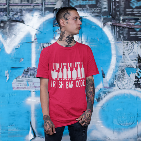 Person wearing a red t-shirt with text standing in front of a graffiti-covered wall.