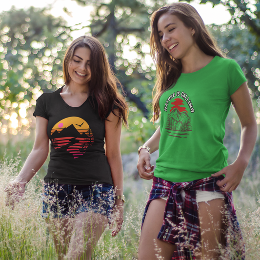 Two women walking in a field wearing t-shirts with graphic designs.