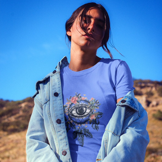 Person wearing a purple t-shirt with a graphic design outdoors