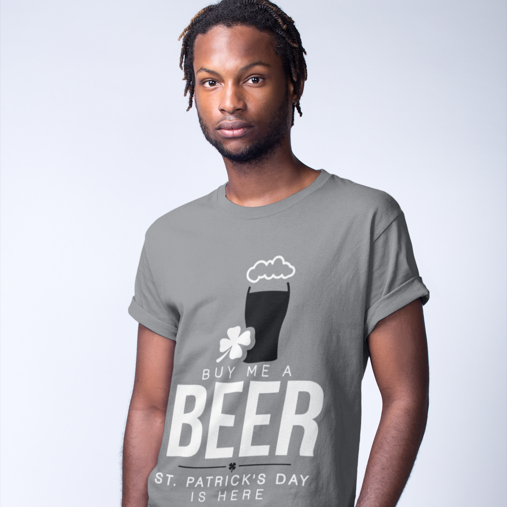 Man wearing a gray t-shirt with a St. Patrick's Day design, standing against a plain background.