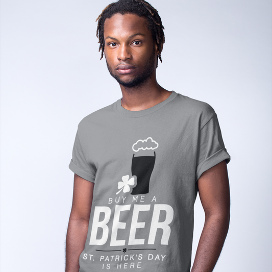 Man wearing a gray t-shirt with a St. Patrick's Day design, standing against a plain background.